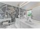 Well-lit bathroom featuring double sinks, geometric design, and large mirror at 7235 Sharpsburg Blvd, New Port Richey, FL 34653