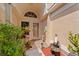 Charming front entry with decorative plants, a small rock fountain, and a brick-paved walkway at 7235 Sharpsburg Blvd, New Port Richey, FL 34653
