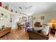 Open-concept living room with hardwood floors, neutral walls, a high ceiling, and natural light flooding in at 7235 Sharpsburg Blvd, New Port Richey, FL 34653