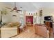 Open living room with hardwood floors, vaulted ceiling with ceiling fan, and comfortable furniture at 7235 Sharpsburg Blvd, New Port Richey, FL 34653