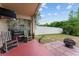 Charming outdoor patio features seating, a grill, and views of the backyard at 7235 Sharpsburg Blvd, New Port Richey, FL 34653