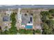 An aerial view of a home featuring a private pool, solar panels, and a spacious backyard enclosed by a fence at 7285 Nightwalker Rd, Weeki Wachee, FL 34613