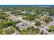 A charming aerial view of a residential community, highlighting lush green trees and well-maintained houses at 7285 Nightwalker Rd, Weeki Wachee, FL 34613