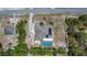 An aerial view of a home featuring a private pool, solar panels, and a spacious backyard enclosed by a fence at 7285 Nightwalker Rd, Weeki Wachee, FL 34613