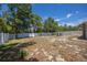Backyard featuring a white fence, offering space for activities, gardening, or outdoor enjoyment at 7285 Nightwalker Rd, Weeki Wachee, FL 34613