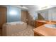 Bathroom boasts a soaking tub, separate vanity, and tiled floor at 7285 Nightwalker Rd, Weeki Wachee, FL 34613