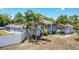 Attractive single-Gathering home featuring classic columns and manicured landscaping, enhanced by mature palm trees at 7285 Nightwalker Rd, Weeki Wachee, FL 34613