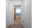 Hallway with bathroom view featuring a soaking tub at 7285 Nightwalker Rd, Weeki Wachee, FL 34613