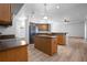 Open concept kitchen with wood cabinets, an island with built in outlets, and stainless steel appliances at 7285 Nightwalker Rd, Weeki Wachee, FL 34613