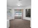 Living room with view of screened-in pool area through sliding glass doors at 7285 Nightwalker Rd, Weeki Wachee, FL 34613