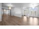 Spacious living area with laminate wood flooring, modern lighting, and access to the front entrance at 7285 Nightwalker Rd, Weeki Wachee, FL 34613