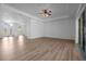 Bright living room with hard wood floors and a view to the front entrance at 7285 Nightwalker Rd, Weeki Wachee, FL 34613