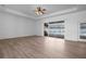 Comfortable primary bedroom with laminate wood flooring, ceiling fan and sliding doors leading to the outdoor patio at 7285 Nightwalker Rd, Weeki Wachee, FL 34613