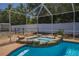 Inviting pool and spa feature stone accents, screened in area and a privacy fence at 7285 Nightwalker Rd, Weeki Wachee, FL 34613