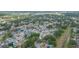 Wide aerial shot showing neighborhood with tree-lined streets, homes with pools, and green spaces at 7903 Heather Ct, Tampa, FL 33634