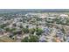 Expansive aerial view of a residential community with mature trees and nearby shopping centers at 7903 Heather Ct, Tampa, FL 33634