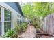 Secluded backyard with stone path and lush landscaping at 7903 Heather Ct, Tampa, FL 33634