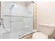 Bright bathroom features a shower with glass door and neutral tile at 7903 Heather Ct, Tampa, FL 33634