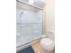 Bright bathroom features a shower with glass door and neutral tile at 7903 Heather Ct, Tampa, FL 33634