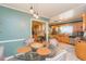 View of a well lit dining area with access to the kitchen featuring oak cabinets and stainless appliances at 7903 Heather Ct, Tampa, FL 33634