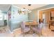 Dining area with a glass table and upholstered chairs with access to the front door and other living areas at 7903 Heather Ct, Tampa, FL 33634