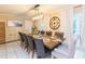Inviting dining room with a large dining table, stylish seating, and an elegant clock on the wall at 7903 Heather Ct, Tampa, FL 33634