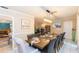 Well-lit dining room with a long table, dark chairs, and access to the living area at 7903 Heather Ct, Tampa, FL 33634