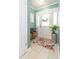 Foyer with a white front door, floral rug, console table, and tile flooring at 7903 Heather Ct, Tampa, FL 33634