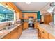 Bright kitchen features granite countertops, stainless steel appliances, light wood cabinets and a large island at 7903 Heather Ct, Tampa, FL 33634