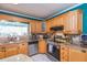 Bright kitchen features granite countertops, stainless steel appliances, and light wood cabinets with a breakfast bar at 7903 Heather Ct, Tampa, FL 33634