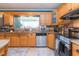 Kitchen with stainless steel appliances, granite countertops, light wood cabinets, and tile flooring at 7903 Heather Ct, Tampa, FL 33634