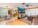Open-concept living room and dining area with hardwood floors and large windows at 7903 Heather Ct, Tampa, FL 33634