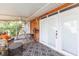 Covered patio with comfortable seating, ceiling fan, and backyard views at 7903 Heather Ct, Tampa, FL 33634