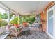 Covered patio with comfortable seating, ceiling fan, and backyard views at 7903 Heather Ct, Tampa, FL 33634