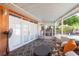 Covered patio with comfortable seating, ceiling fan, and backyard views at 7903 Heather Ct, Tampa, FL 33634