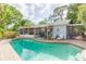 Inviting backyard pool with surrounding brick patio and lush greenery at 7903 Heather Ct, Tampa, FL 33634