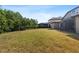 Large backyard showcasing mature trees and partial fencing, providing a private and serene outdoor space at 7911 Hampton Lake Dr, Tampa, FL 33647