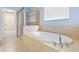 Bathroom featuring an enclosed glass shower and a large soaking tub at 7911 Hampton Lake Dr, Tampa, FL 33647