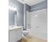 Bright bathroom featuring a shower-tub combination and vanity with a granite countertop at 7911 Hampton Lake Dr, Tampa, FL 33647