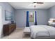 Comfortable bedroom with stylish décor, a ceiling fan, and natural light at 7911 Hampton Lake Dr, Tampa, FL 33647