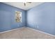 Serene bedroom with neutral carpet, a large window, and light blue walls at 7911 Hampton Lake Dr, Tampa, FL 33647