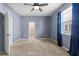 A bright bedroom includes neutral carpeting, a closet, and a large window at 7911 Hampton Lake Dr, Tampa, FL 33647