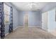 Bright bedroom featuring a walk-in closet and neutral carpeting at 7911 Hampton Lake Dr, Tampa, FL 33647
