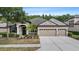 Well-maintained home with a three-car garage, mature landscaping, and a clean, inviting facade at 7911 Hampton Lake Dr, Tampa, FL 33647