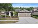 Charming single-story home with a three-car garage, well-manicured landscaping, and inviting curb appeal at 7911 Hampton Lake Dr, Tampa, FL 33647