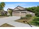 Side view of a home with a three-car garage and manicured landscaping at 7911 Hampton Lake Dr, Tampa, FL 33647