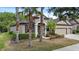 Inviting single-story home with a well-kept lawn, lush landscaping, and a spacious three-car garage at 7911 Hampton Lake Dr, Tampa, FL 33647