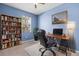 Cozy home office with built-in bookcase, a comfortable chair, and plenty of natural light at 7911 Hampton Lake Dr, Tampa, FL 33647