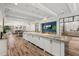 Spacious white kitchen offers a large island with stone countertops and modern pendant lighting at 7911 Hampton Lake Dr, Tampa, FL 33647