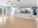 Open living space features tile floors, a kitchen bar, and light blue walls, with backyard access at 7911 Hampton Lake Dr, Tampa, FL 33647